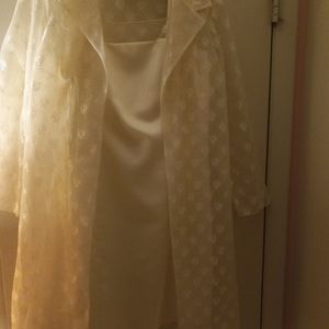 A new, never worn after five cream colored dress, with a shear coat over it.
